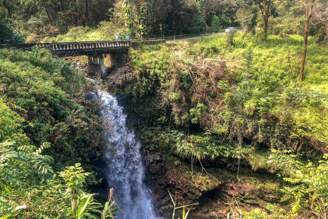 Hikers walk across a bridge on the Road to Hana, one of 59 bridges that exist along the 52-mile roadway.