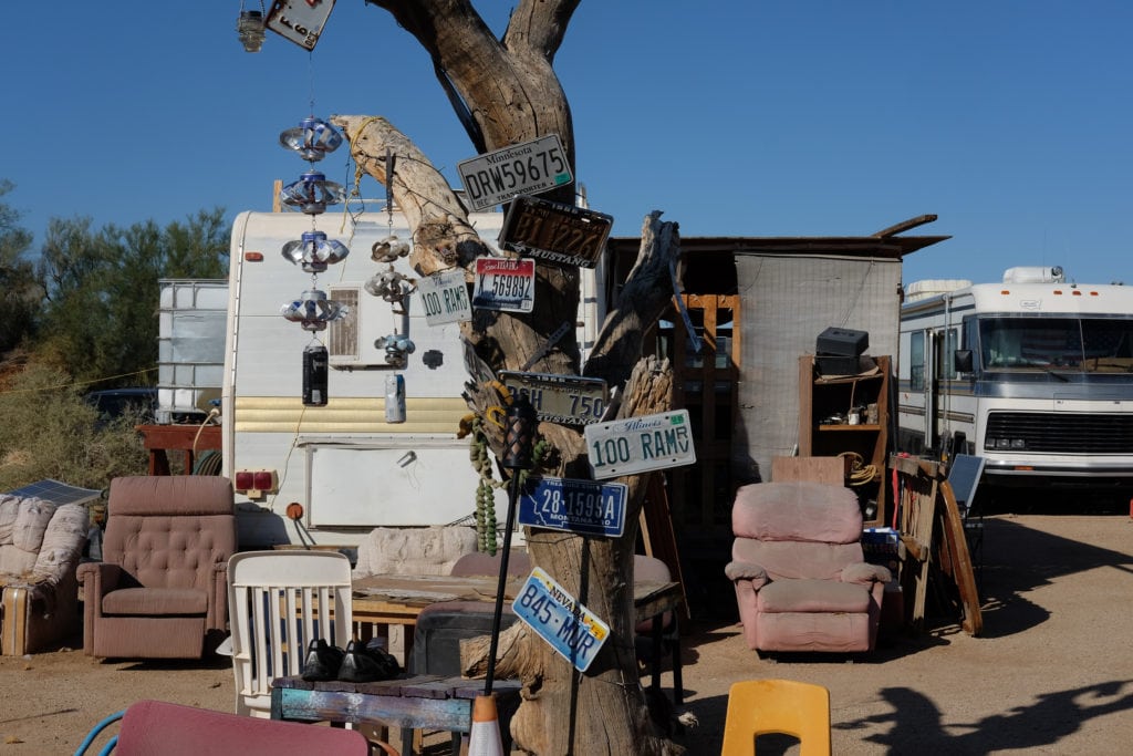 Old license plates and threadbare furniture decorate the camp.