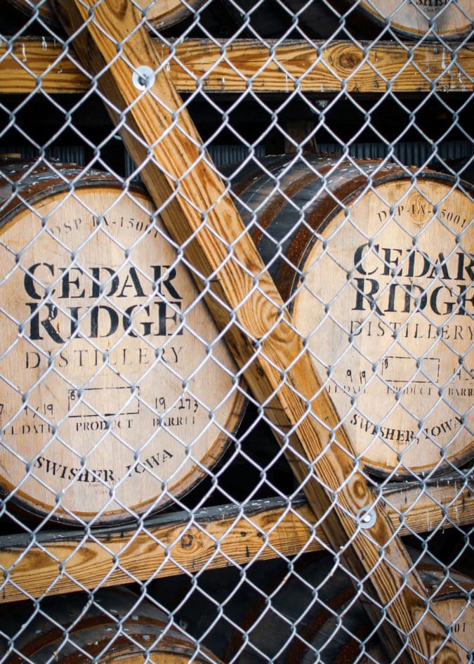 Oak barrels of wine behind a fence at Cedar Ridge Winery in Iowa