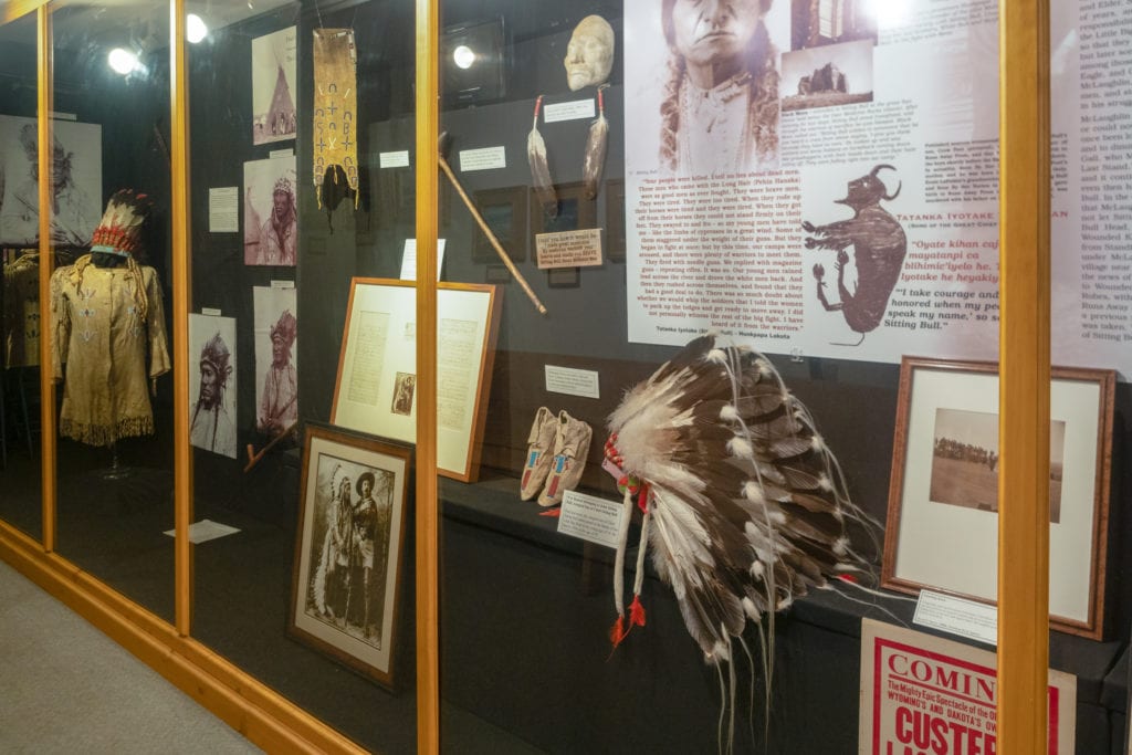 Display case with Sitting Bull's artifacts and photographs.