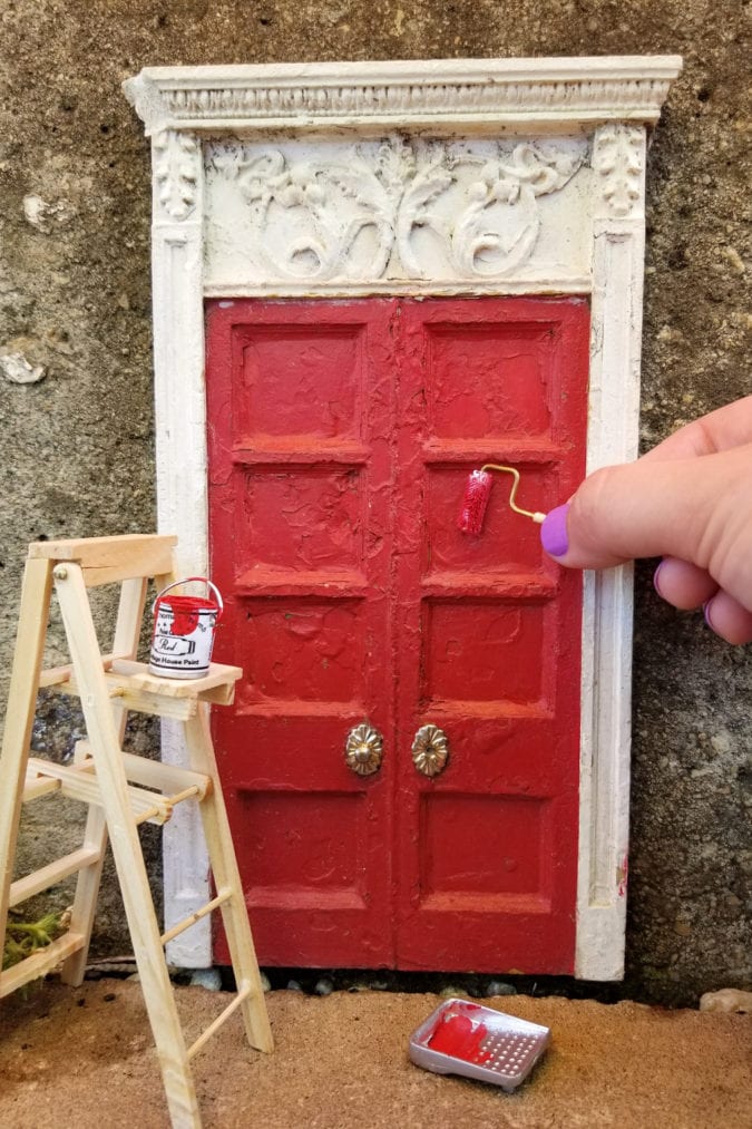 Painting a door.