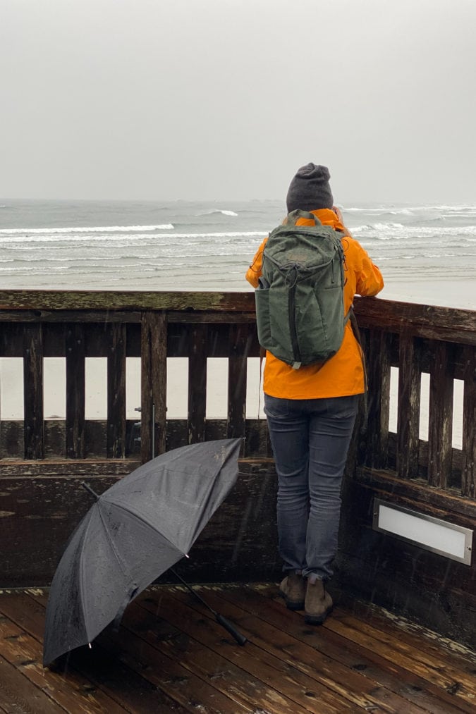 A storm watcher gazes at the ocean in the deck of the Kwisitis visitor Center.