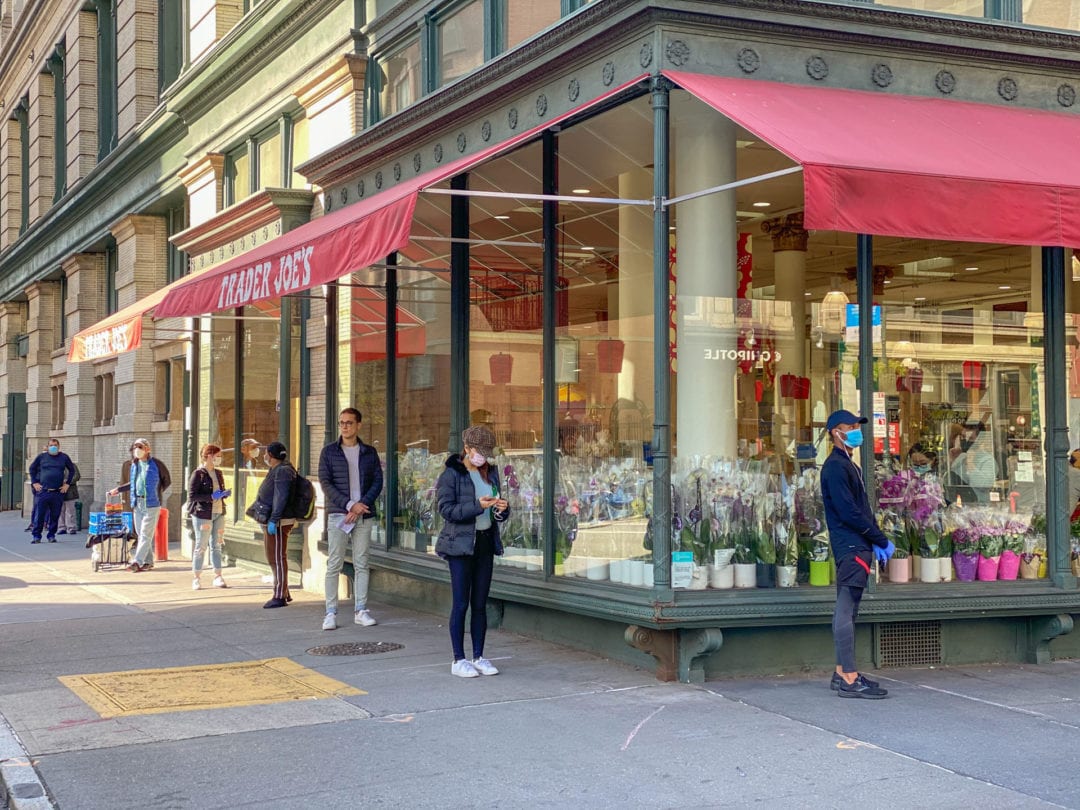 Standing six feet apart and donning face masks, New Yorkers patiently wait in line for provisions to tide them over until restaurants reopen.