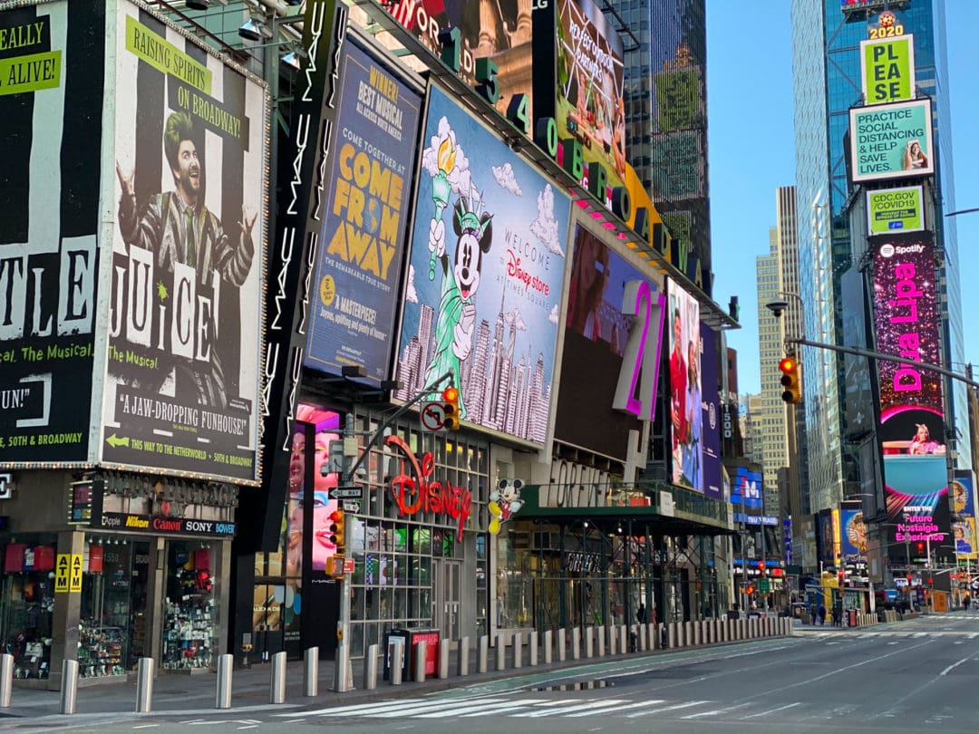 The bright lights of Times Square remain lit and giant LED screens still glitter with ads for the millions of tourists who are no longer there.