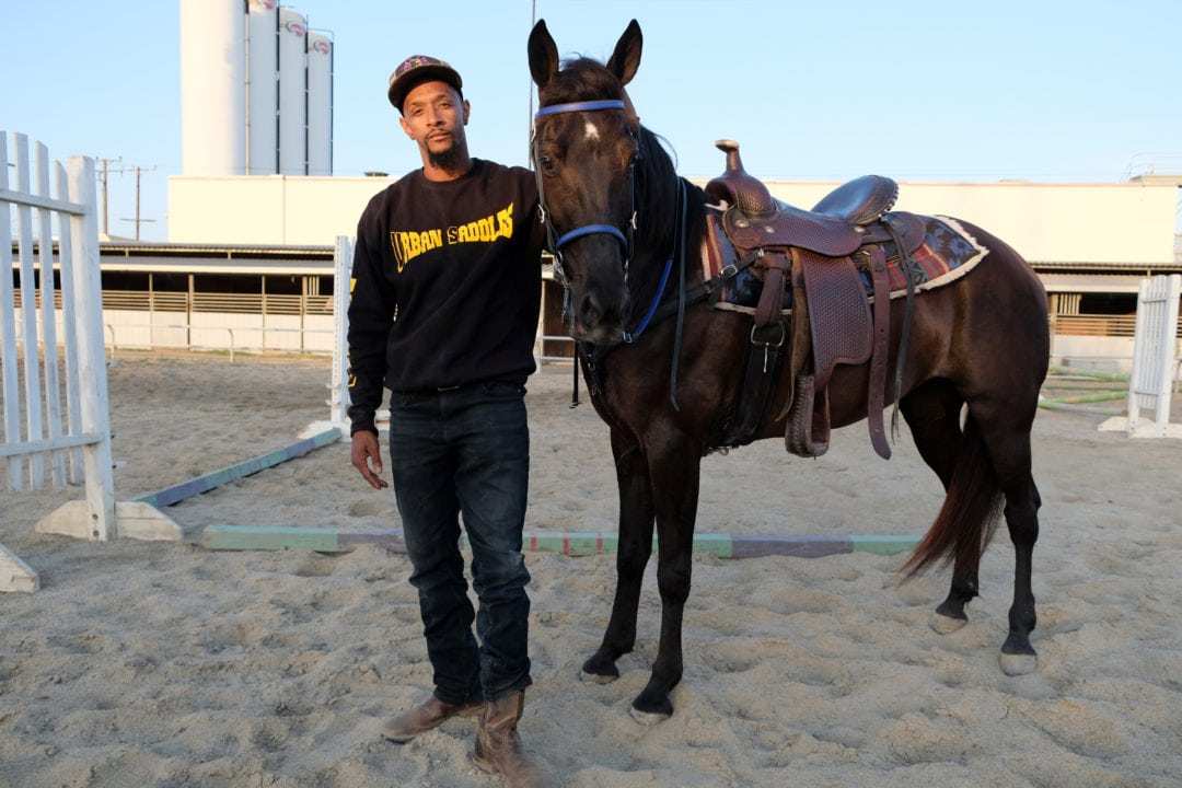 Calvin Gray stands with Dior, an American Quarter Horse. 
