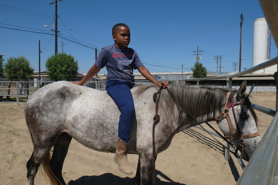 Jordan, age 11, spends time with his new horse Winter. 