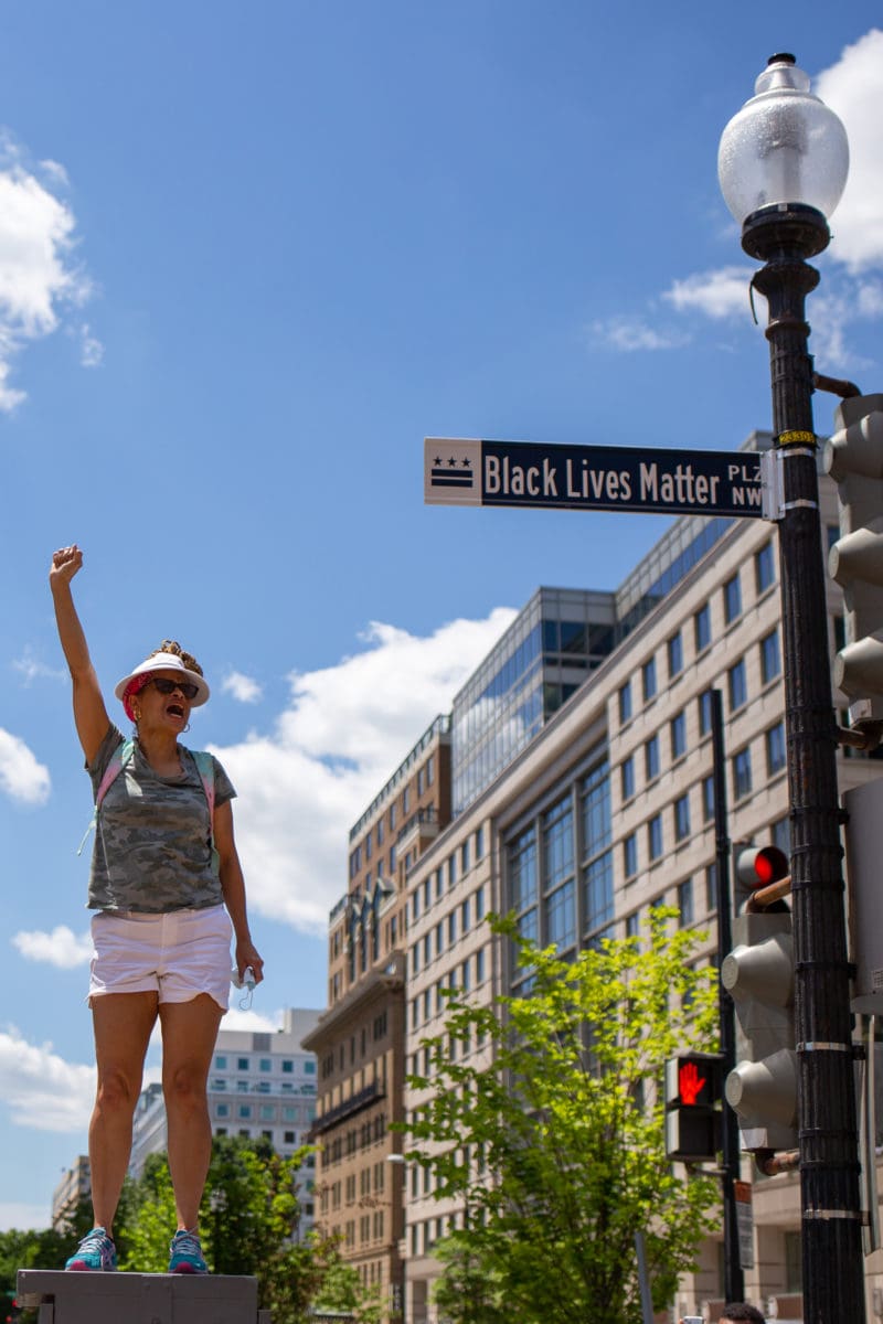 Left: A woman chants “Black lives matter” to a crowd assembled in the newly-named Black Lives Matter Plaza.