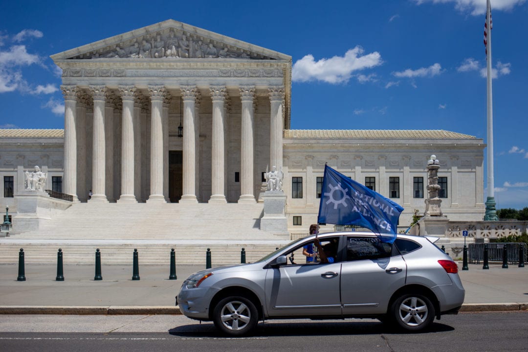A car in front of the Supreme Court.