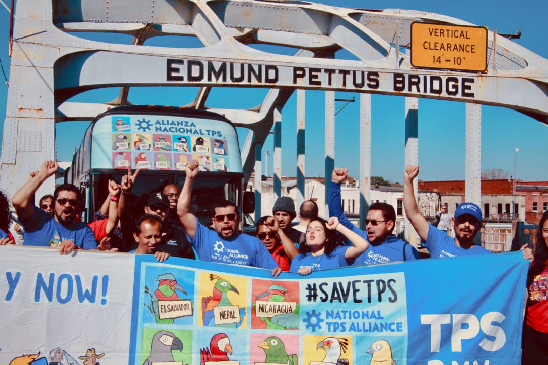 TPS holders marching across the Edmund Pettus Bridge in Alabama.