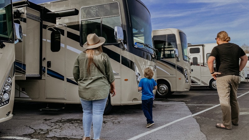 family looking at RVs for sale on a lot