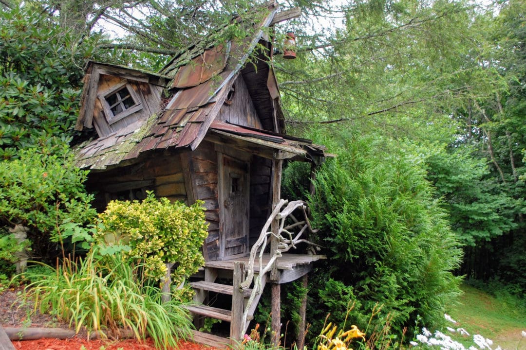 A rustic hut named the Hillbilly House, designed to blend with nature