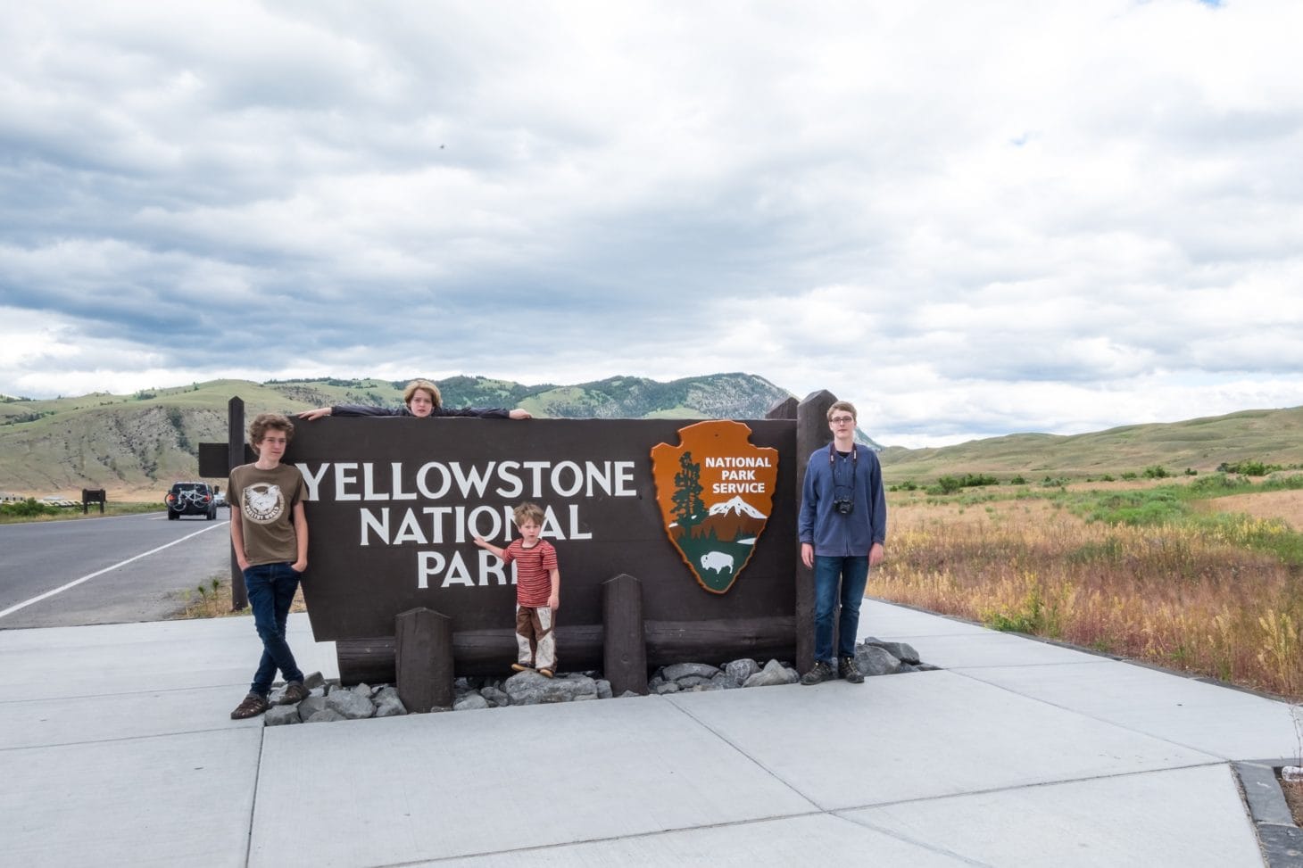 family at Yellowstone national park entrance