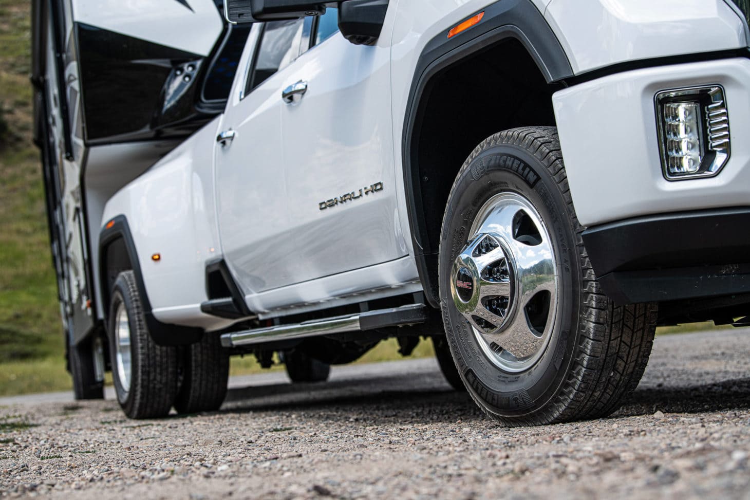 Close up of wheels on a pickup truck towing a travel trailer