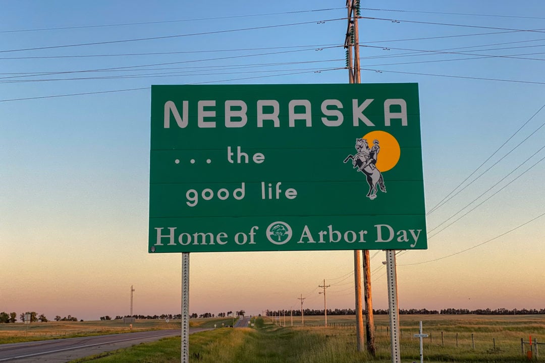 Road sign in Nebraska reading "Home of Arbor Day."