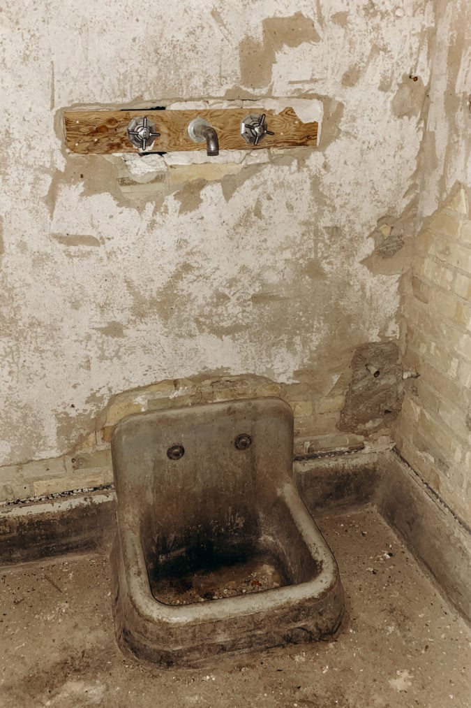 A former patient bathroom in the abandoned cottage.