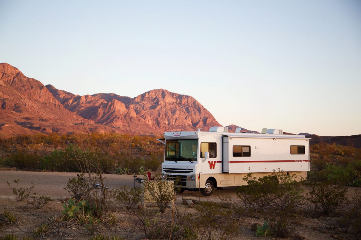 Large RV parked with desert background