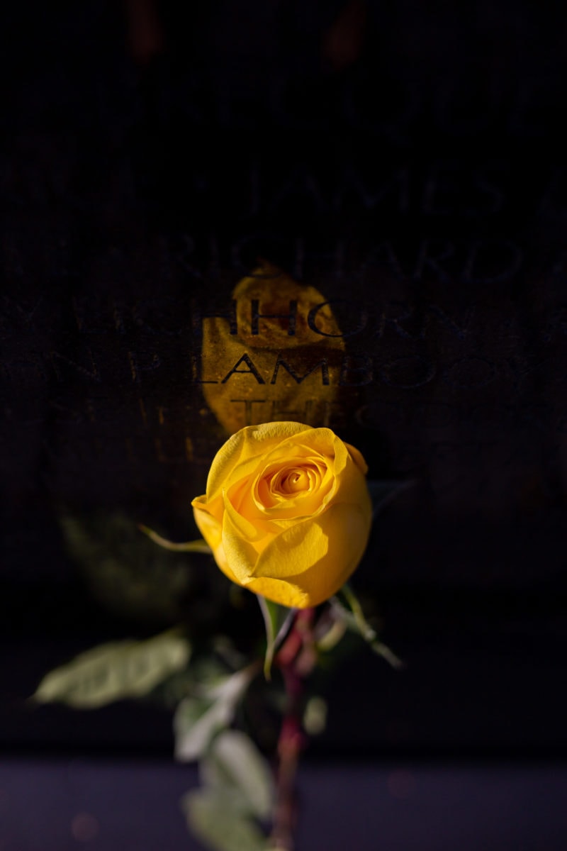 Visitors to the Vietnam Veterans Memorial can look up names in directories located near the wall and leave trinkets, flowers, and flags to commemorate those lost in the 16-year-long war.