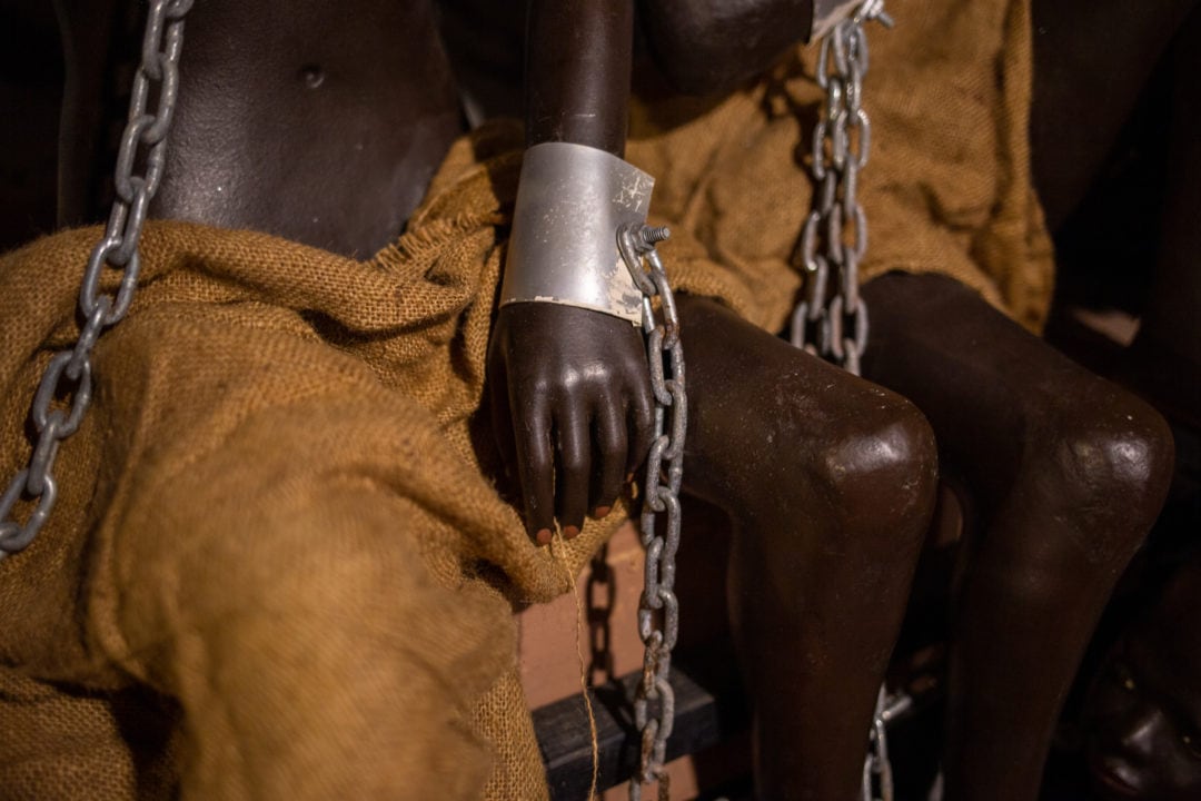 Children in chains in the replica slave ship.