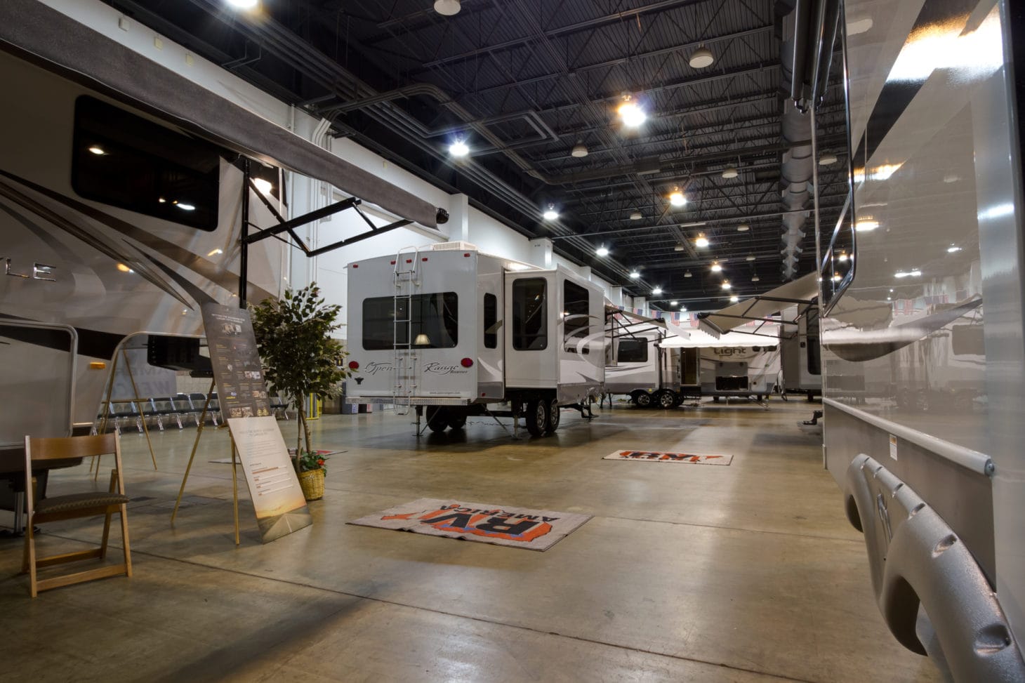 RVs on display at an RV show in a convention center