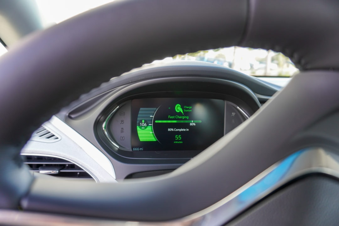 EV dashboard lit up with a charging message: "80% complete in 55 minutes"