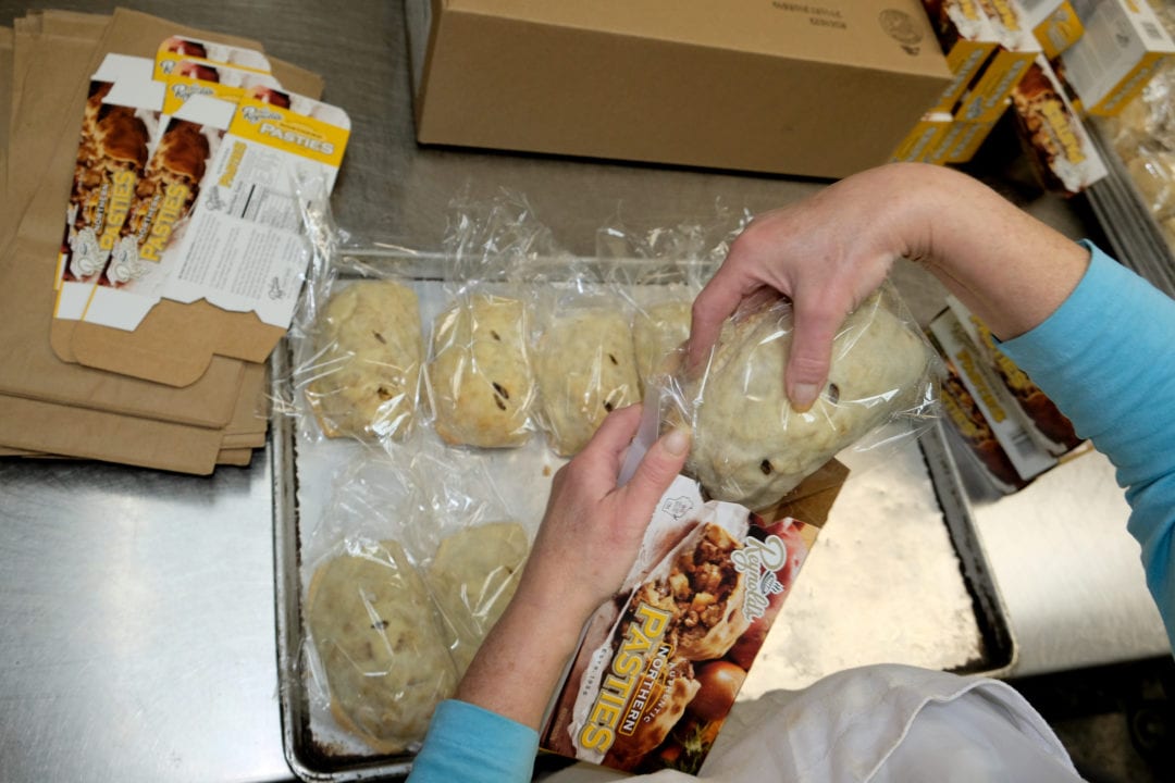 Ms. Pat, a pasty maker for more than 40 years, boxes the par-baked and then frozen pasties to be shipped to retailers throughout Wisconsin. From start to finish, the Reynold's staff handcrafts everything on site.