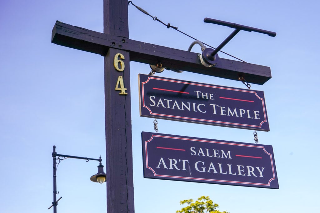 Signs for the Satanic Temple and Salem Art Gallery.