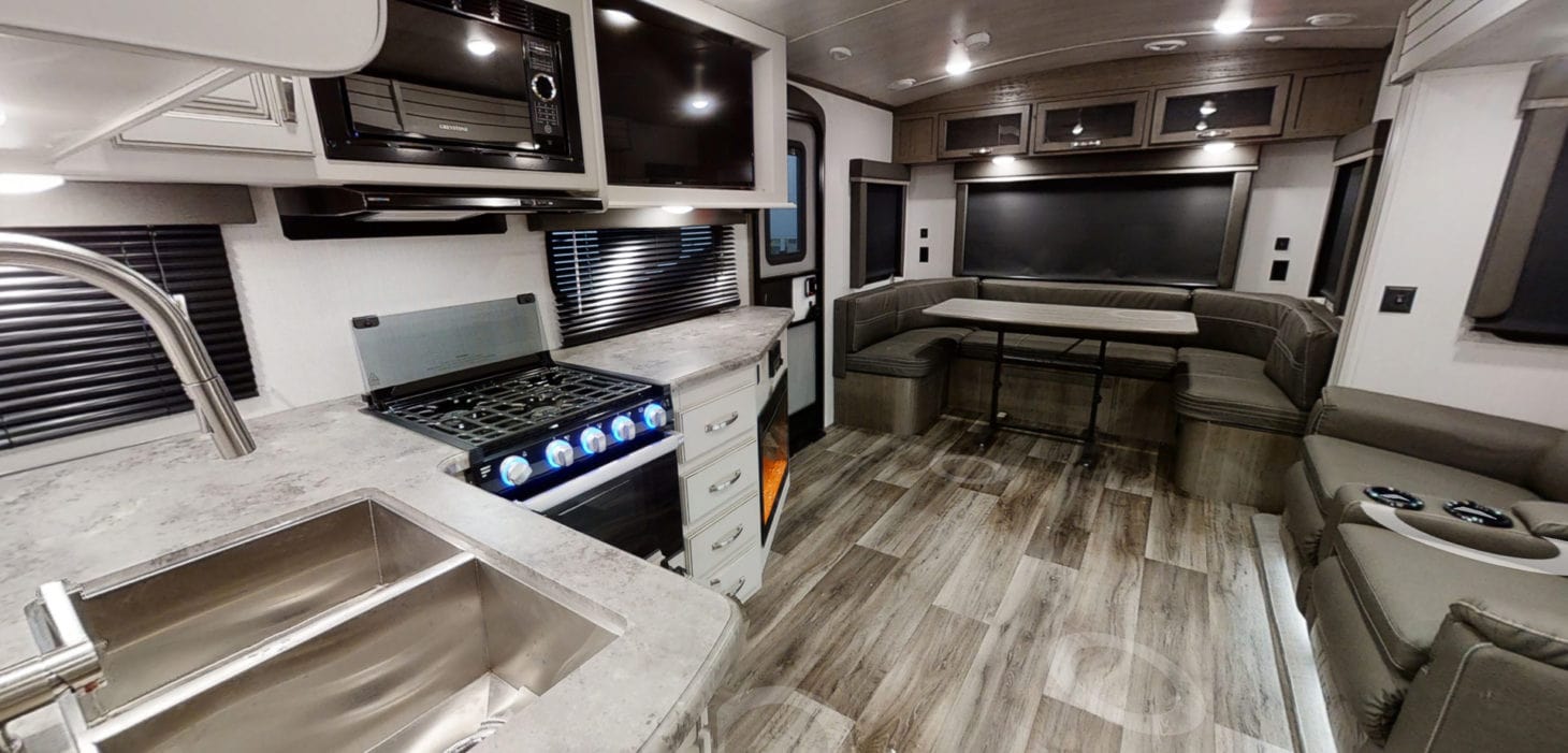 Interior view of large living and kitchen area in travel trailer 