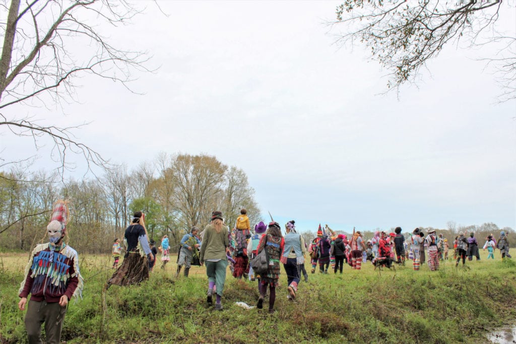 Participants make their way through a field in search of the chicken.