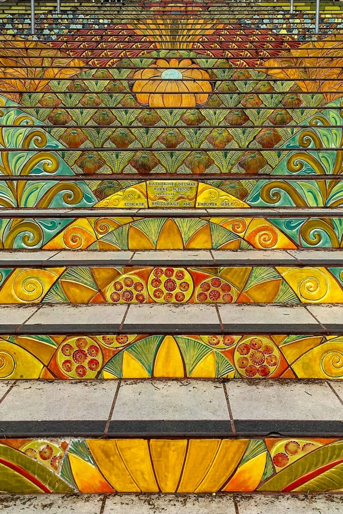 mosaic tiled steps in a yellow, orange and green floral pattern