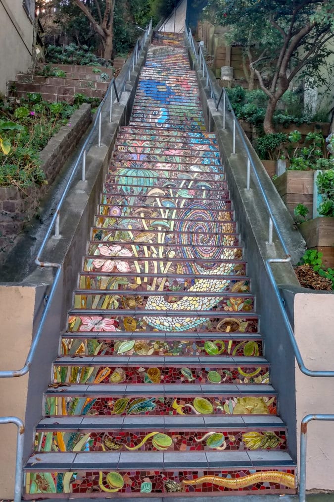 a steep staircase with a tiled mosaic
