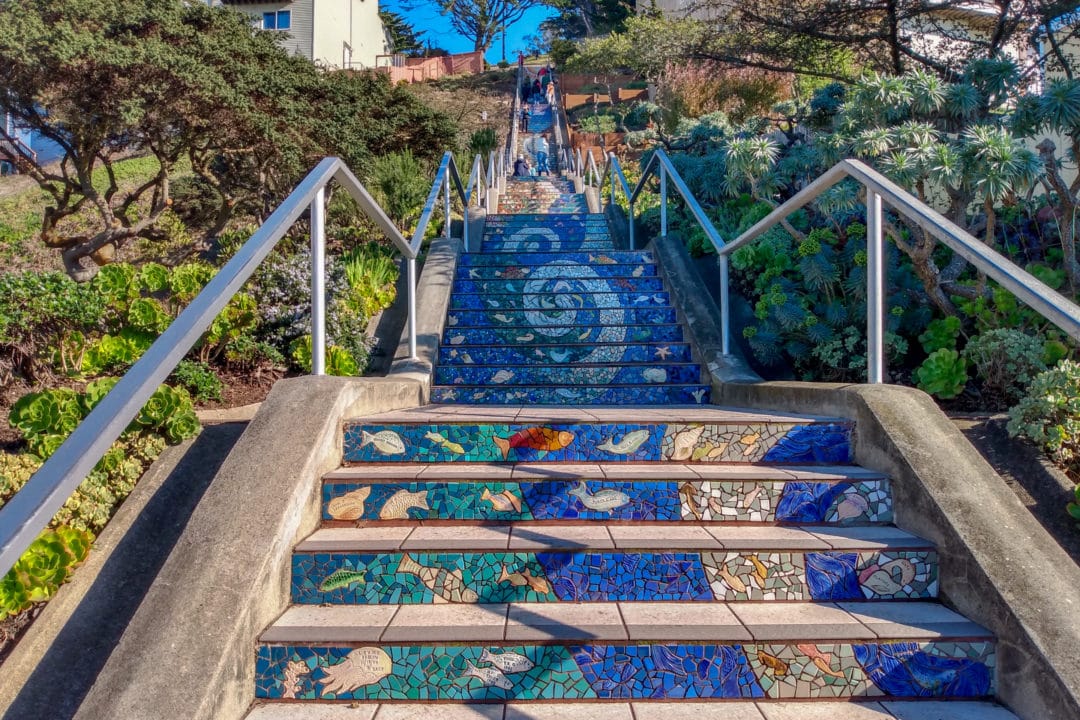 Mosaic tiled steps in swirling blues with fish elements