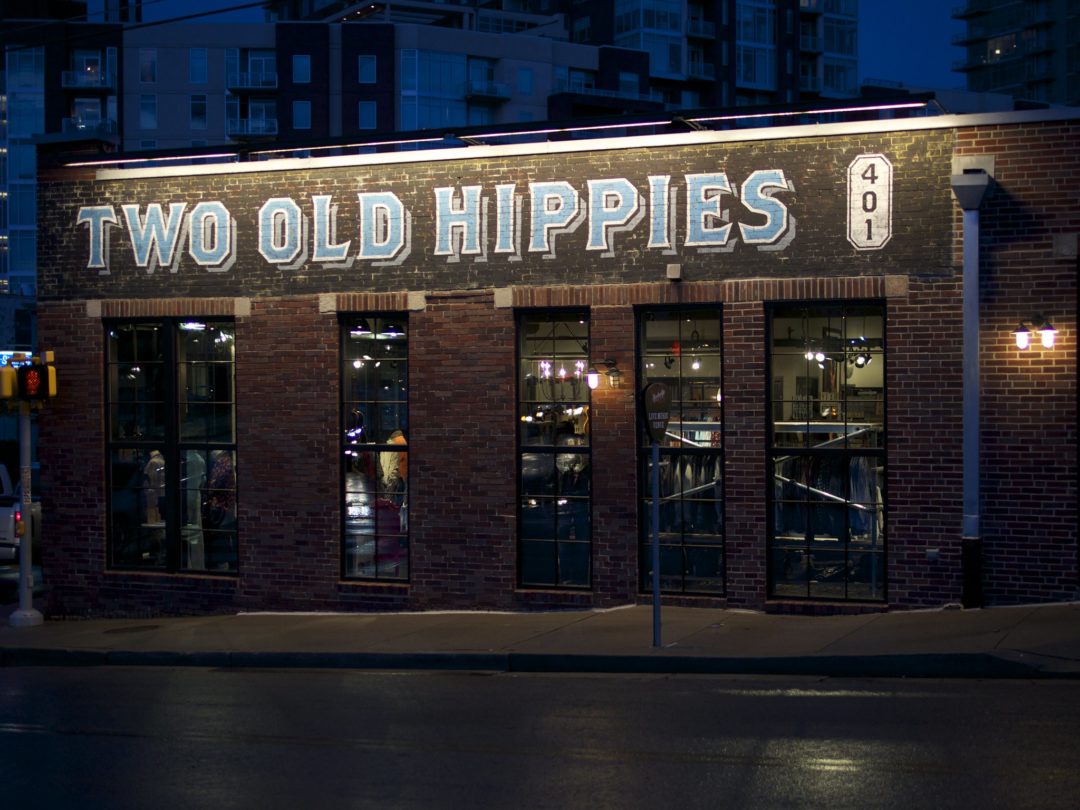 The exterior of Two Old Hippies lit at night