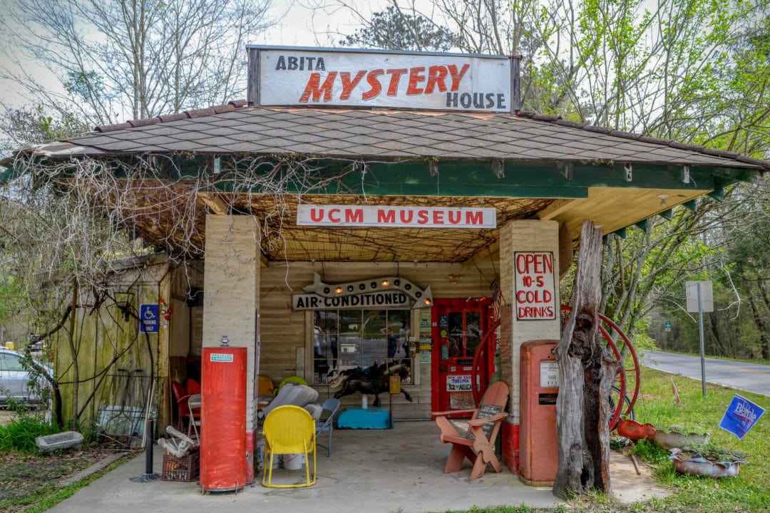 a converted gas station covered in handpainted signs and vintage goods