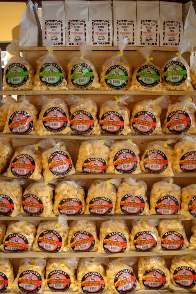 bags of orange cheese curds sit on a shelf