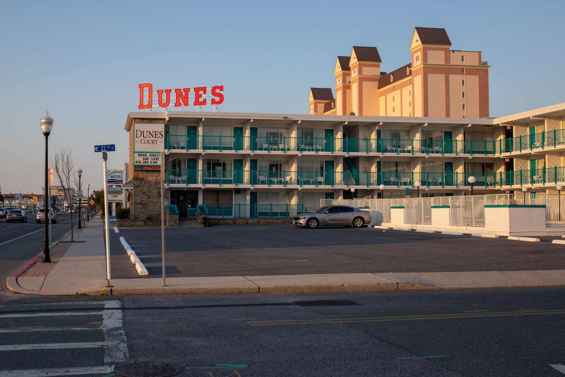 Vintage hotel with green balconies and a sign that reads "Dunes"