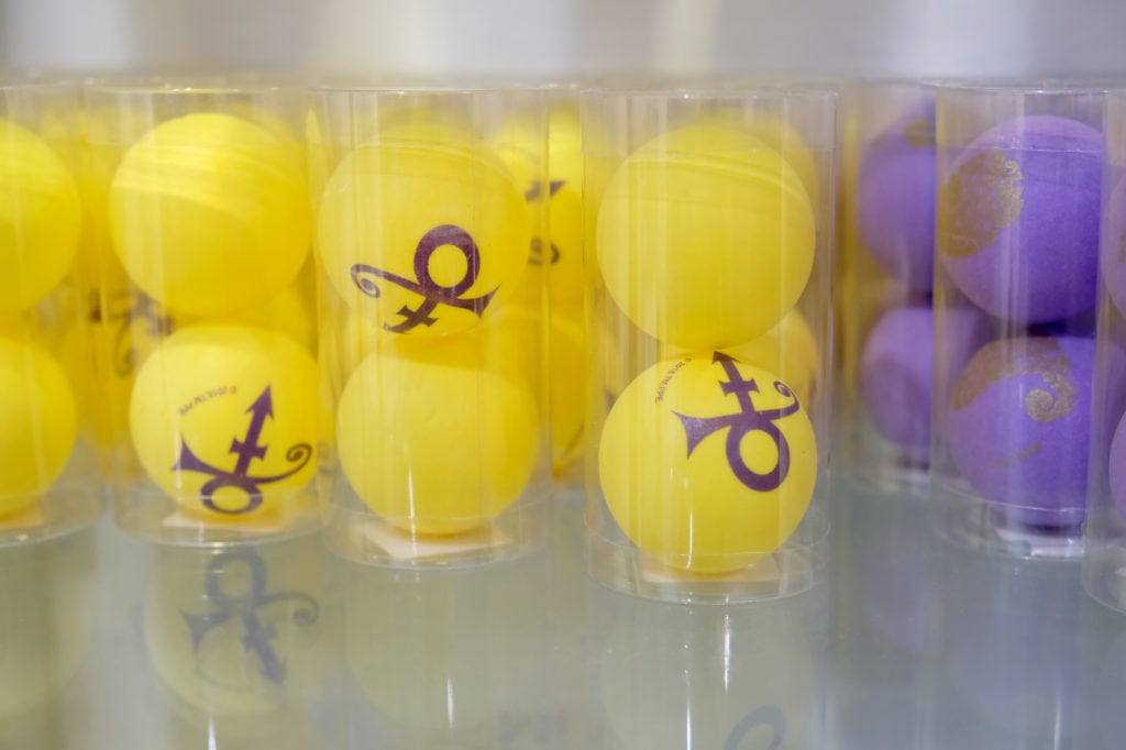 yellow and purple ping pong balls printed with prince's symbol