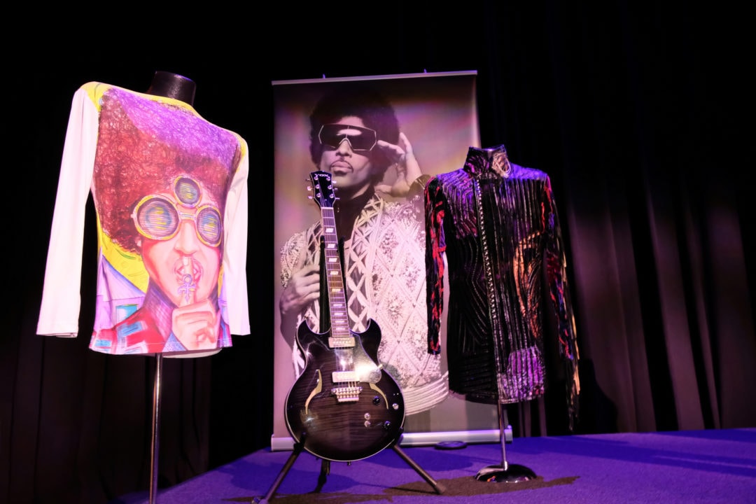 colorful outfits and a guitar used by prince