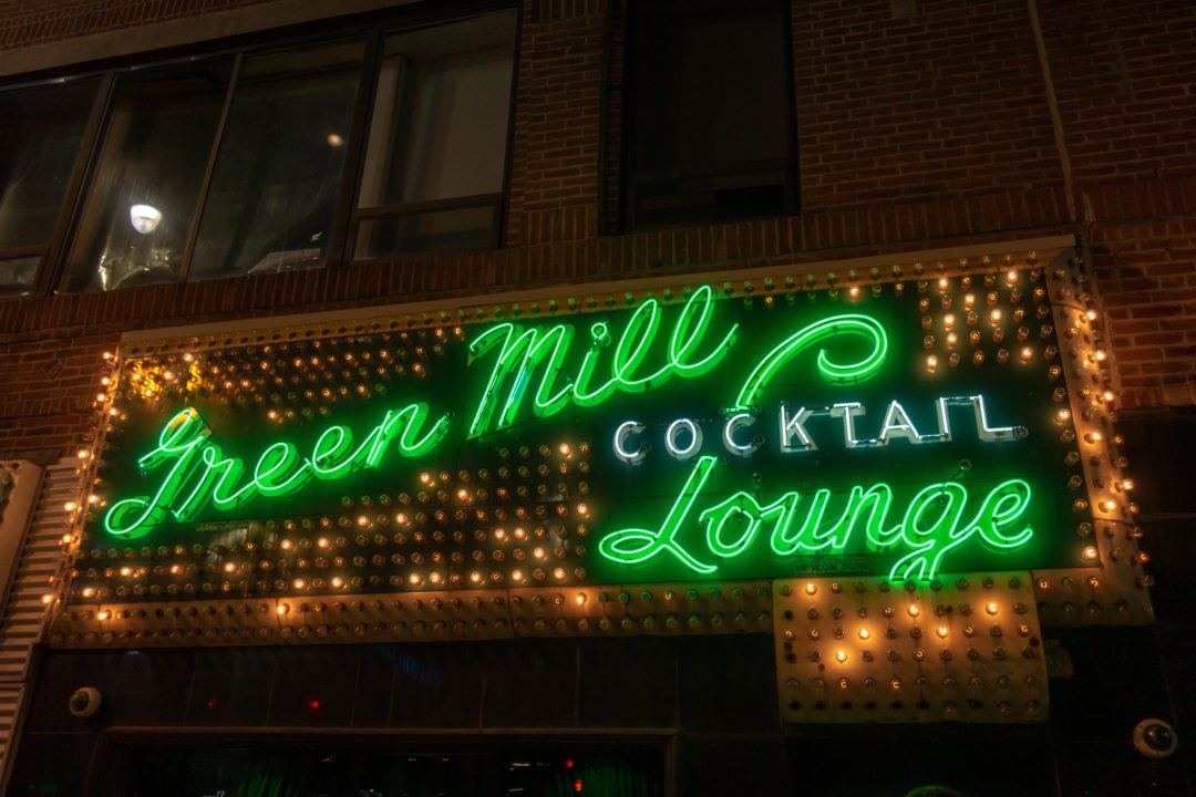Neon green sign above the entrance of the Green Mill Jazz Club