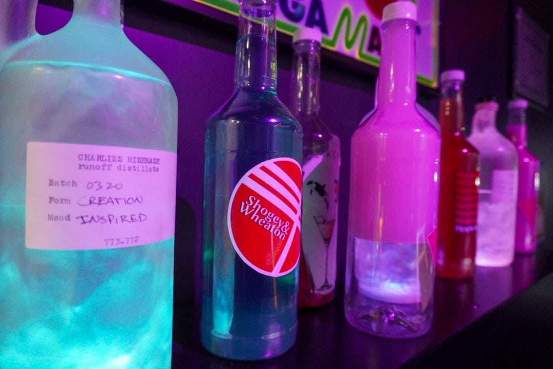 A row of liquor bottles in various colors
