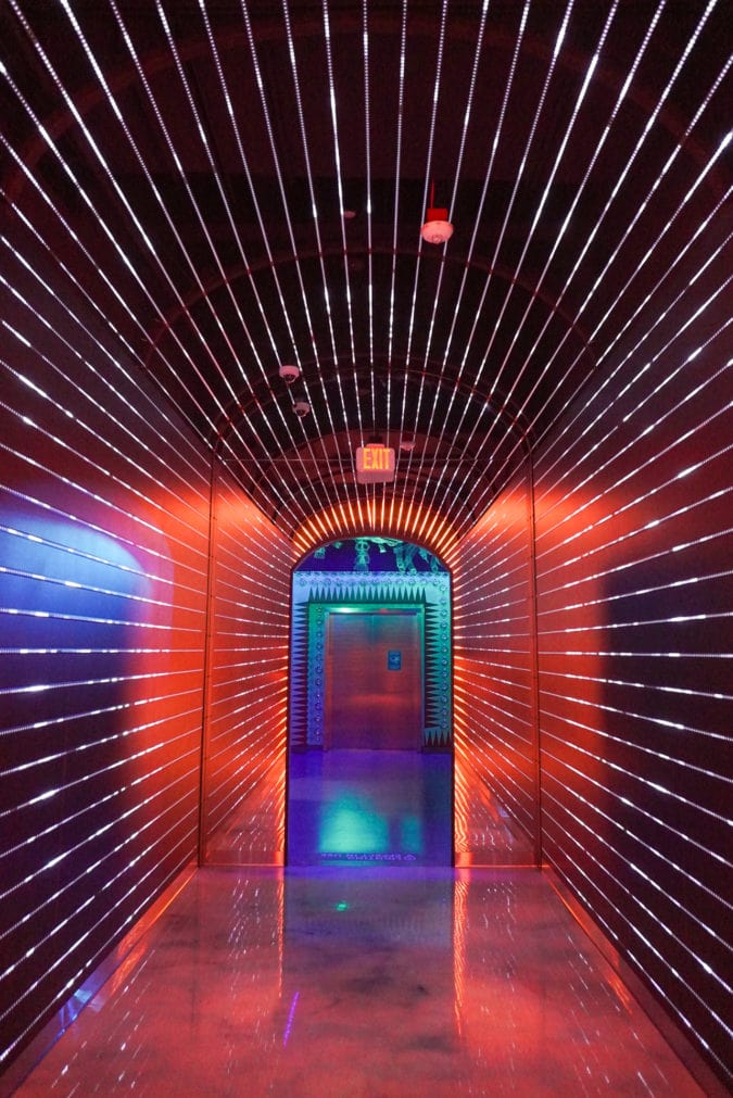 A brightly lit corridor where the light changes color. 