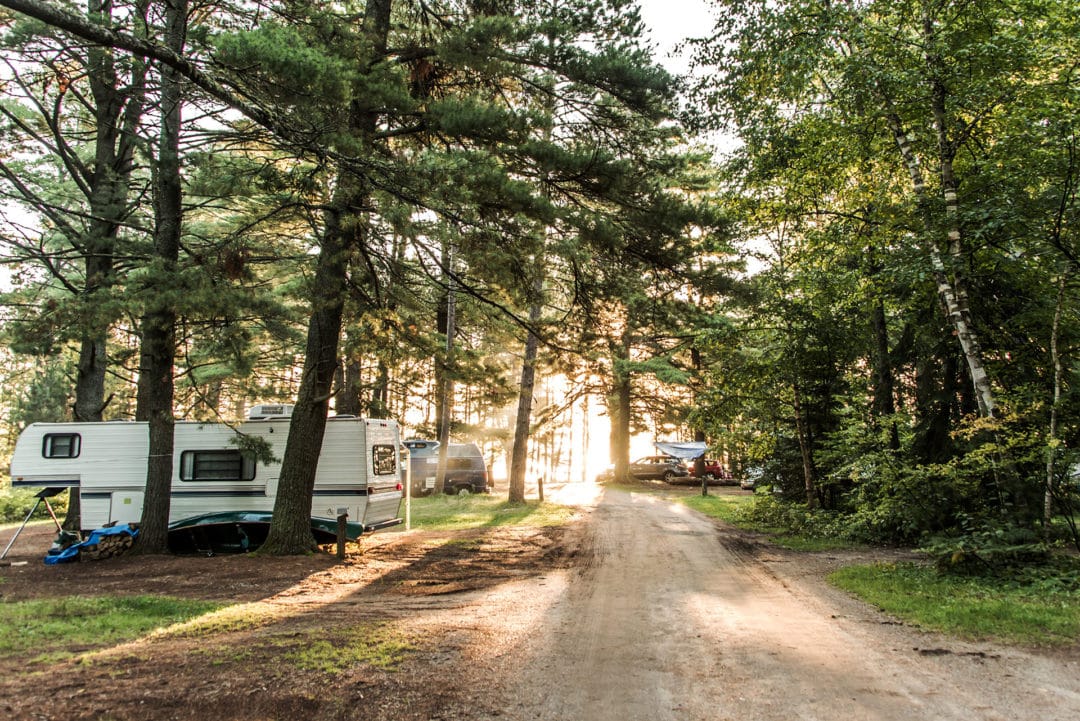 RV parked in a wooded campground