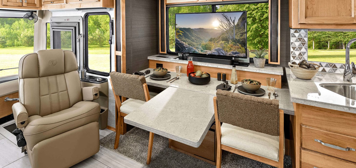 Interior view of an RV with a fold down table for working