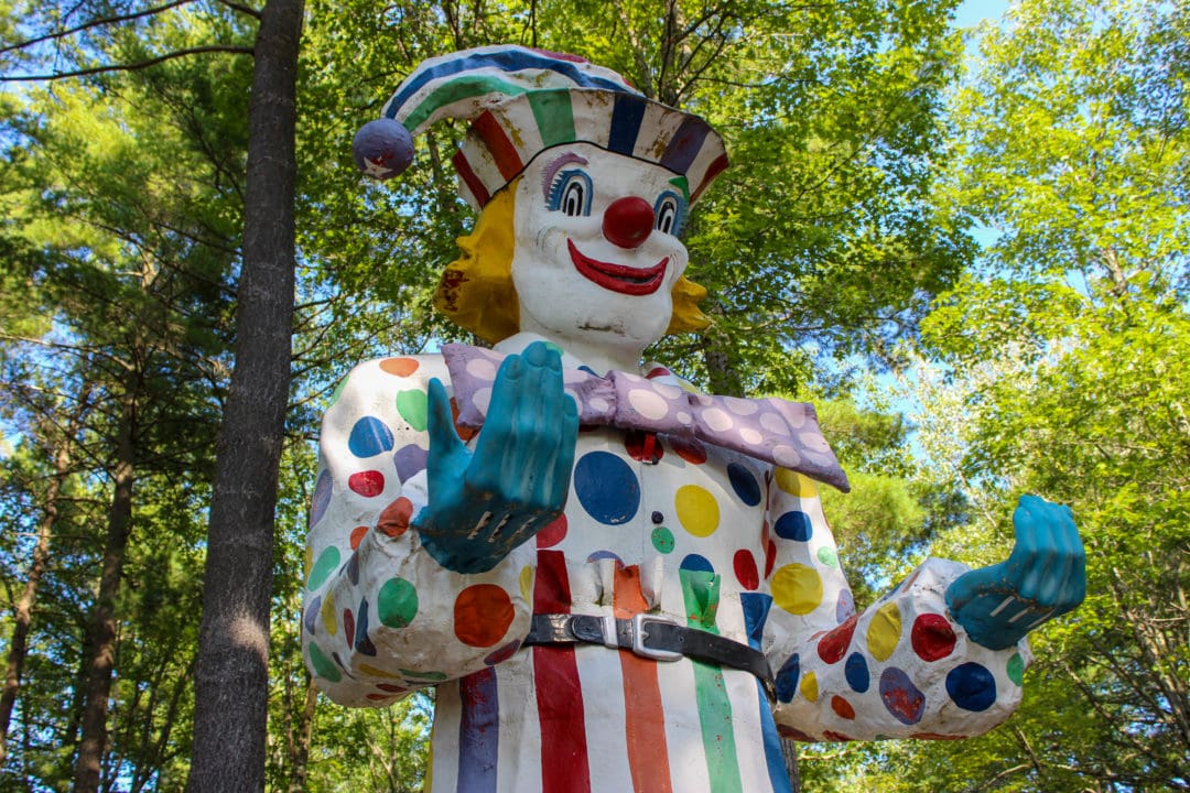 a large fiberglass statue is painted like a colorful clown
