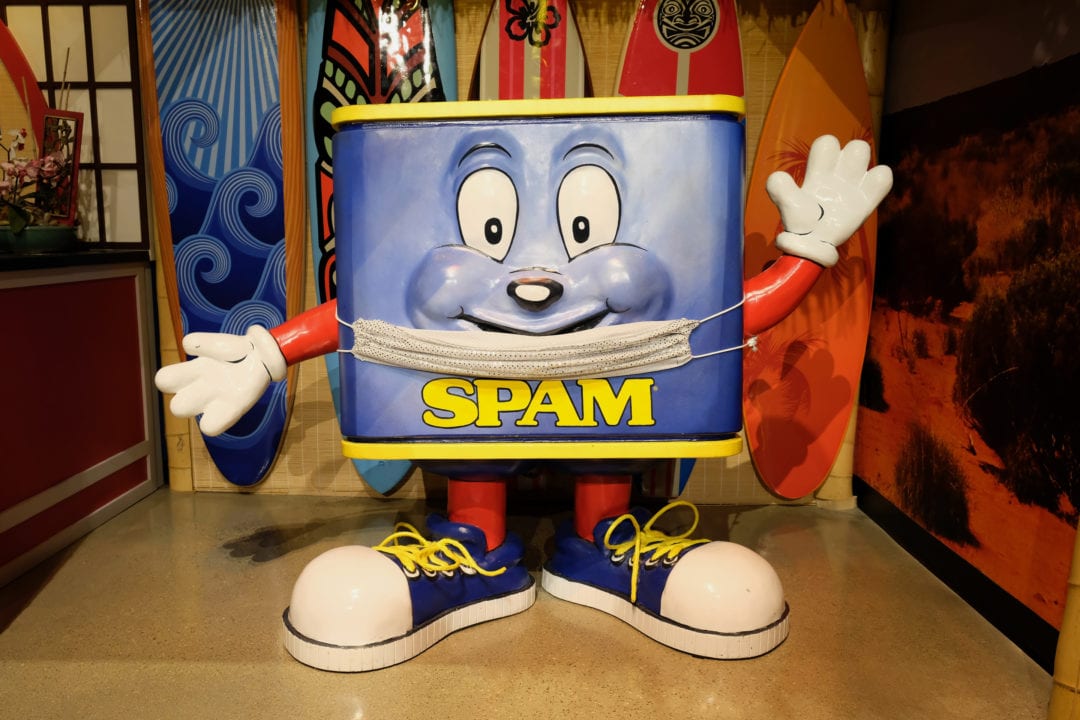 a cartoon spam can mascot with hands, feet and large eyes