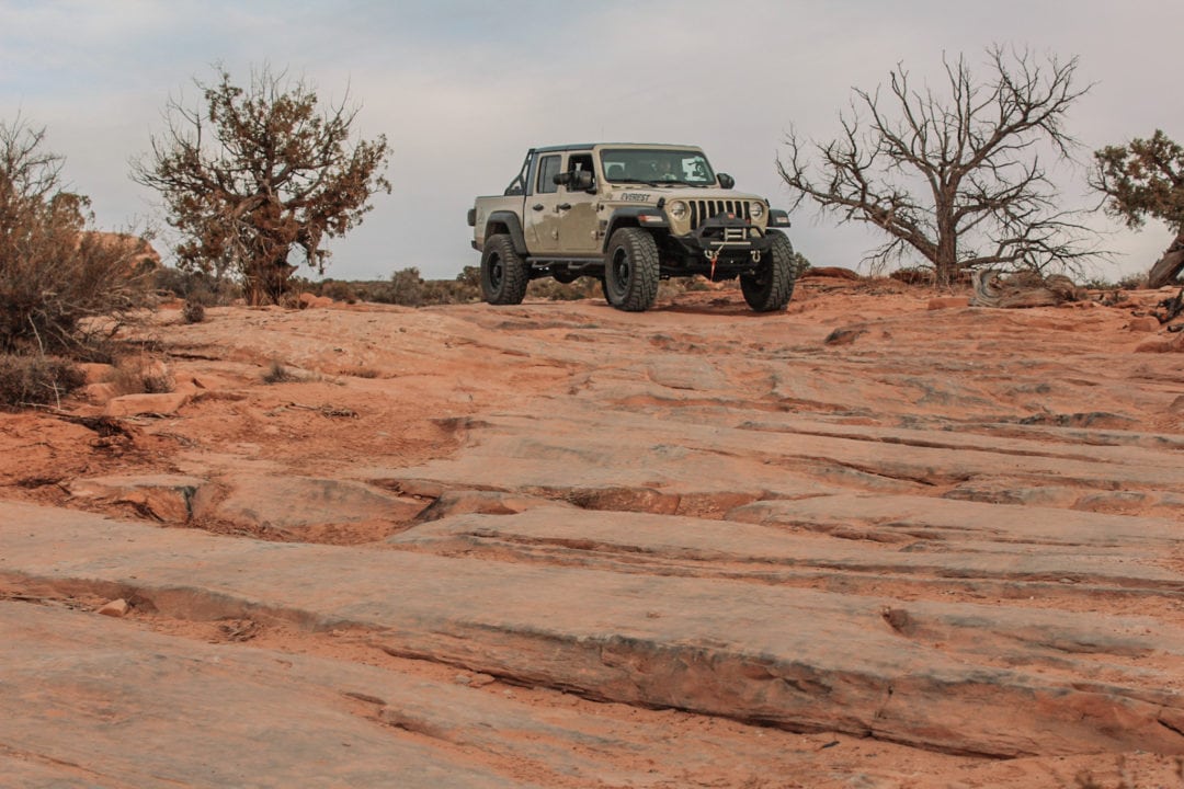 Jeep parked at the top of a rocky desert section