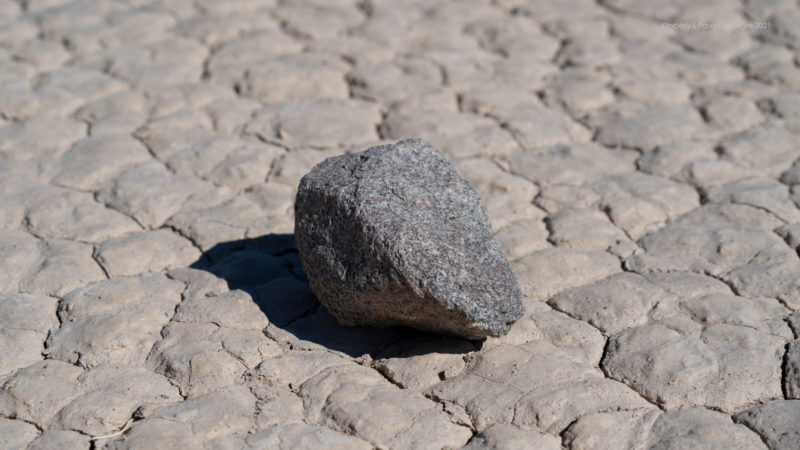 A rock on a desert surface