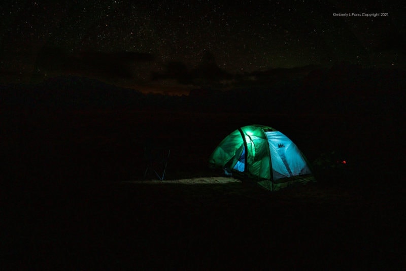 An illuminated tent in the dark