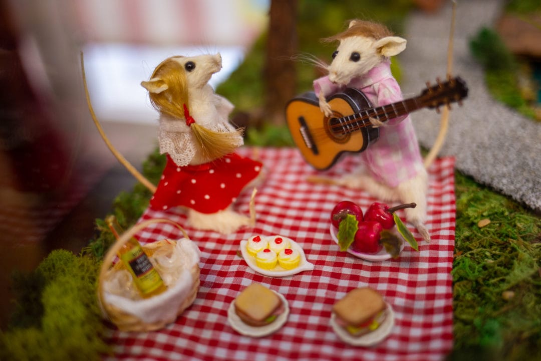 Two taxidermy mice have a picnic while one plays the guitar