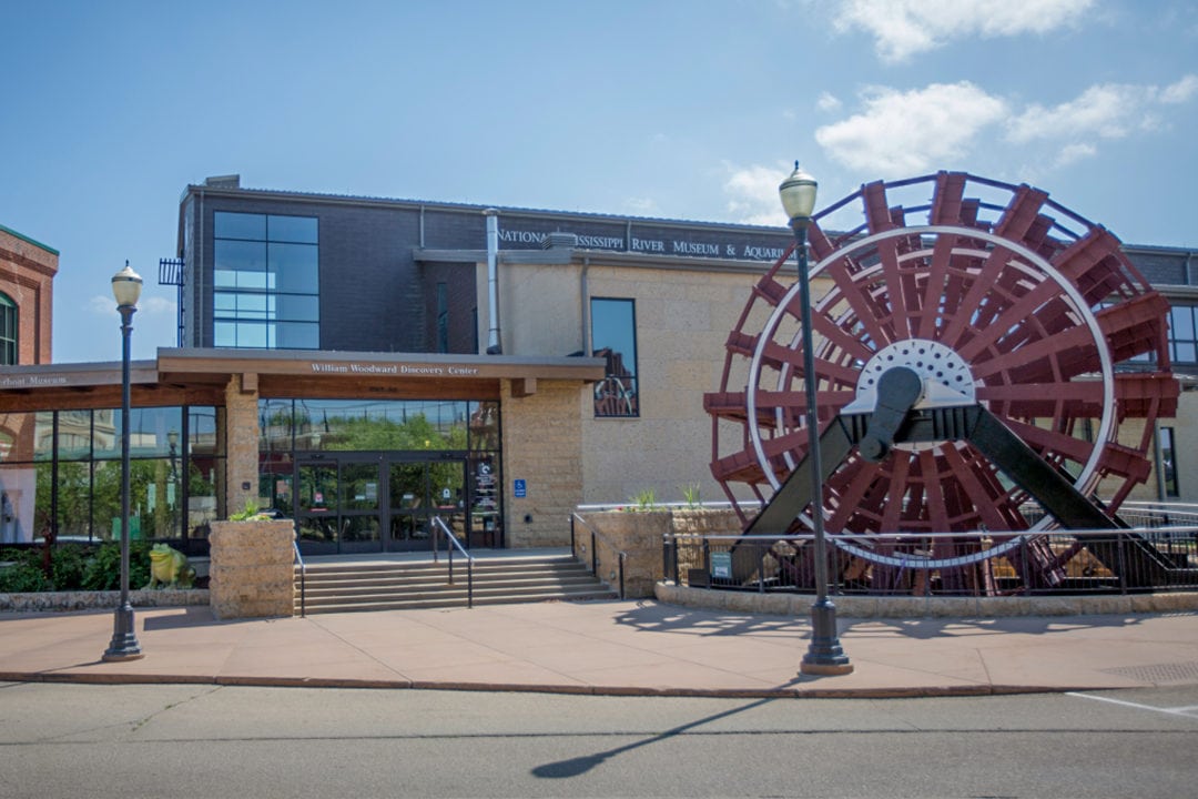 a red paddlewheel sits outside of the National Mississippi River Museum & Aquarium