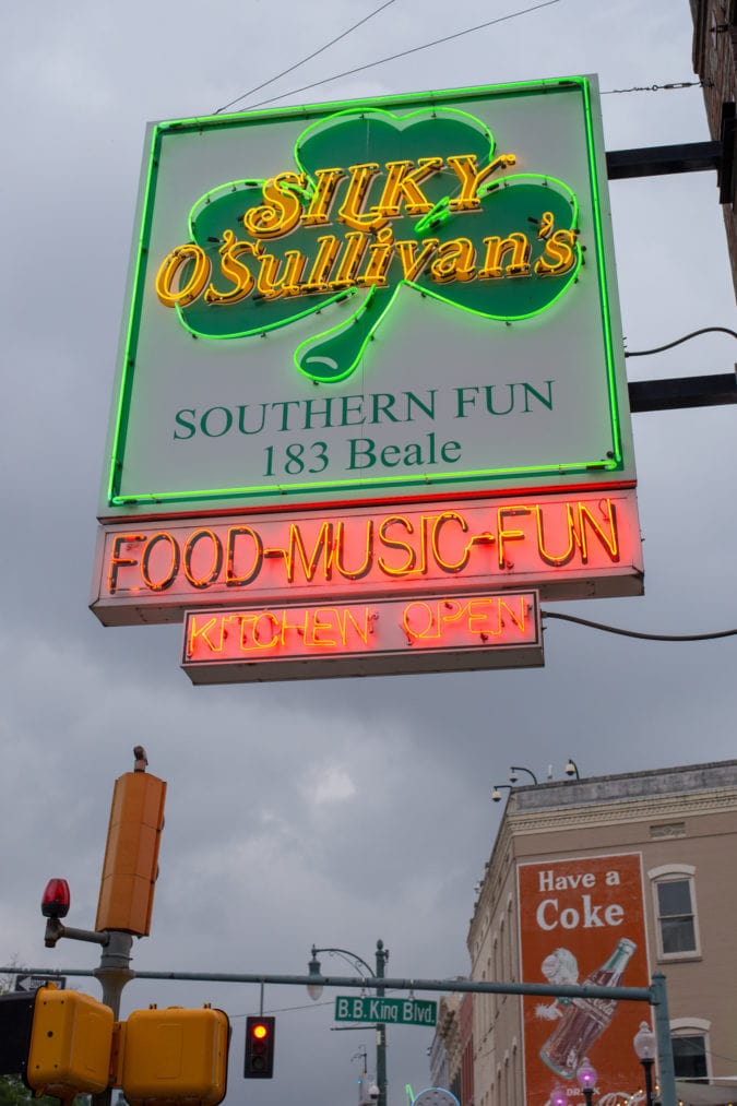 A neon sign featuring a shamrock and the words "Silky O'Sullivan's" and "Food-Music-Fun"